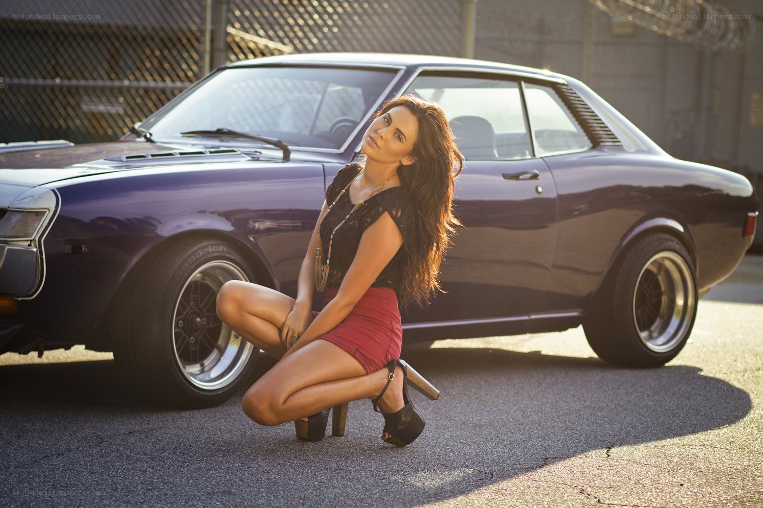 woman posing with classic car