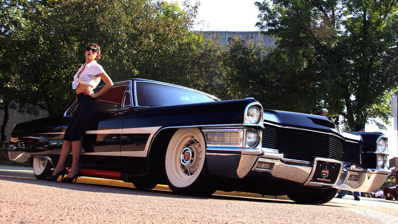 Woman posing with classic car