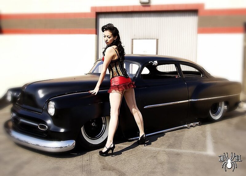 Woman posing with classic car