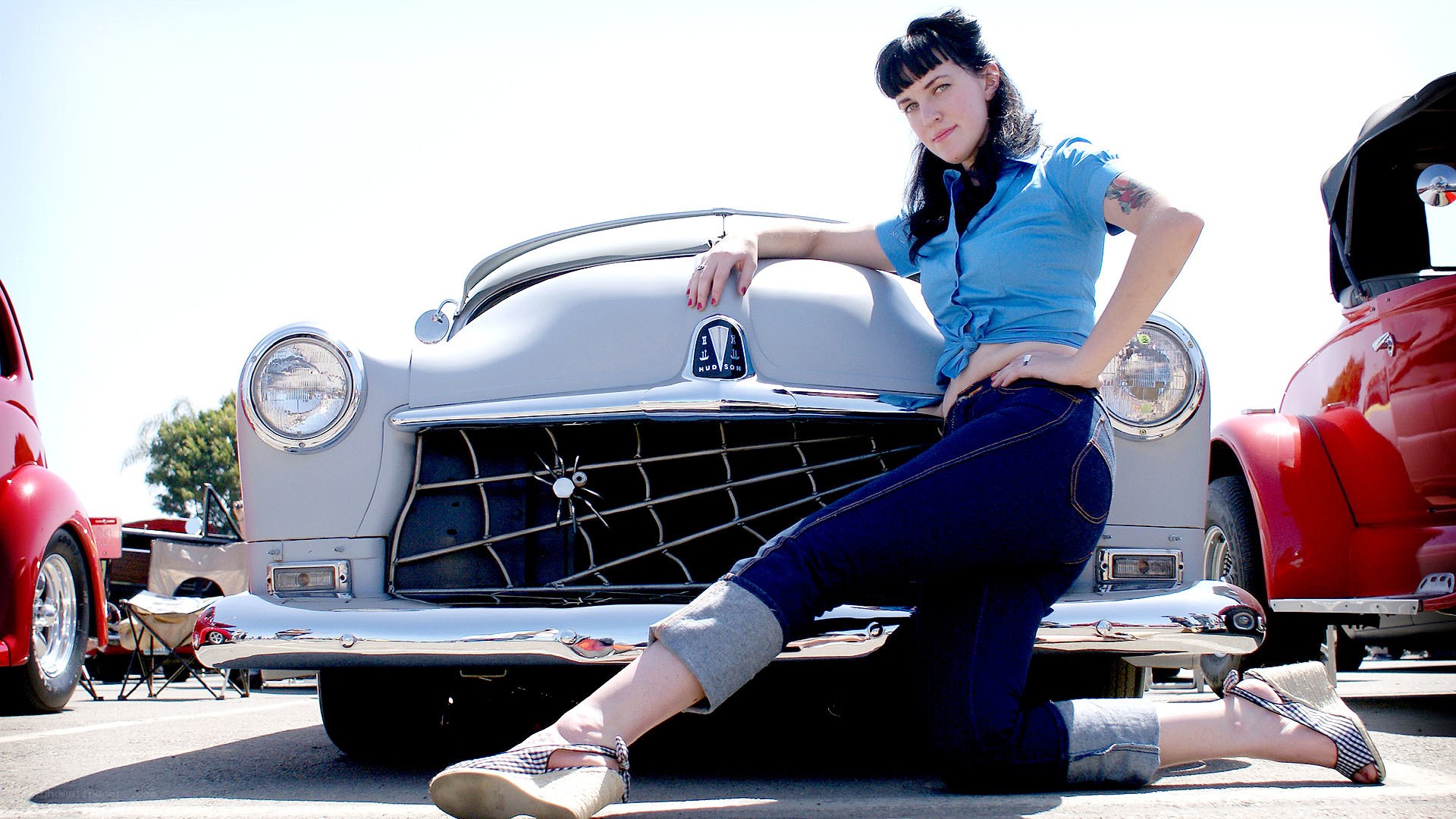 Woman posing with classic car