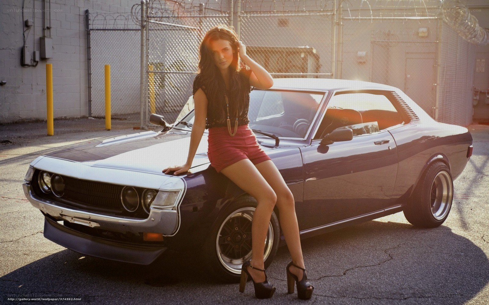 woman posing with classic car