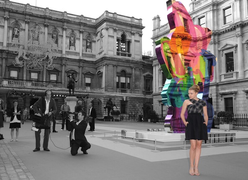 Woman posing with colorful sculpture