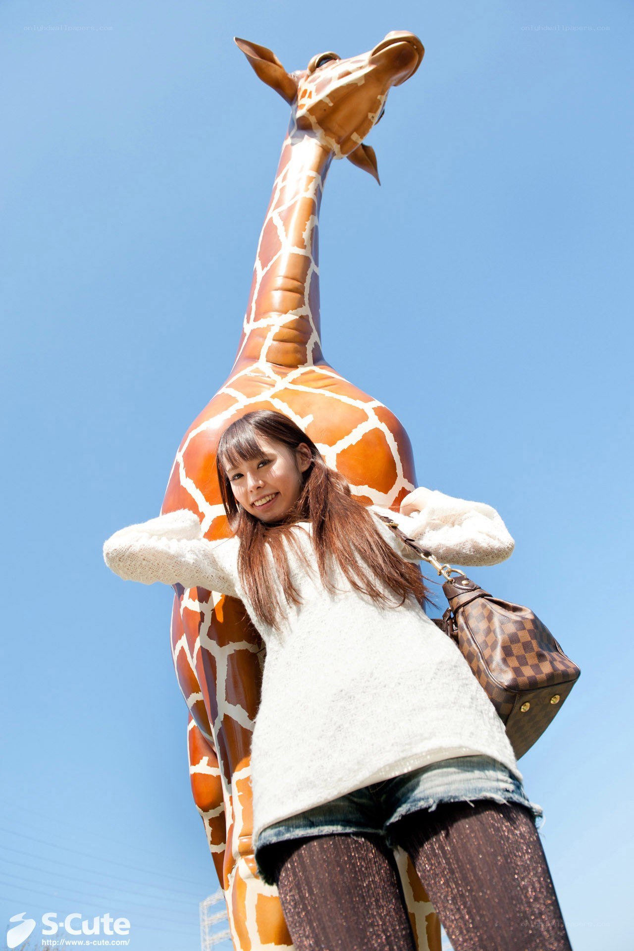 Woman posing with giraffe statue
