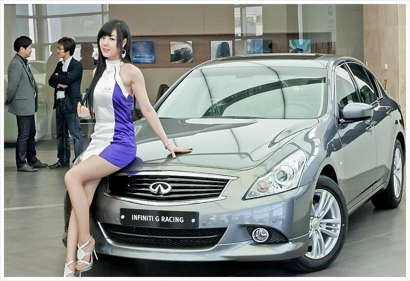 Woman posing with Infiniti car