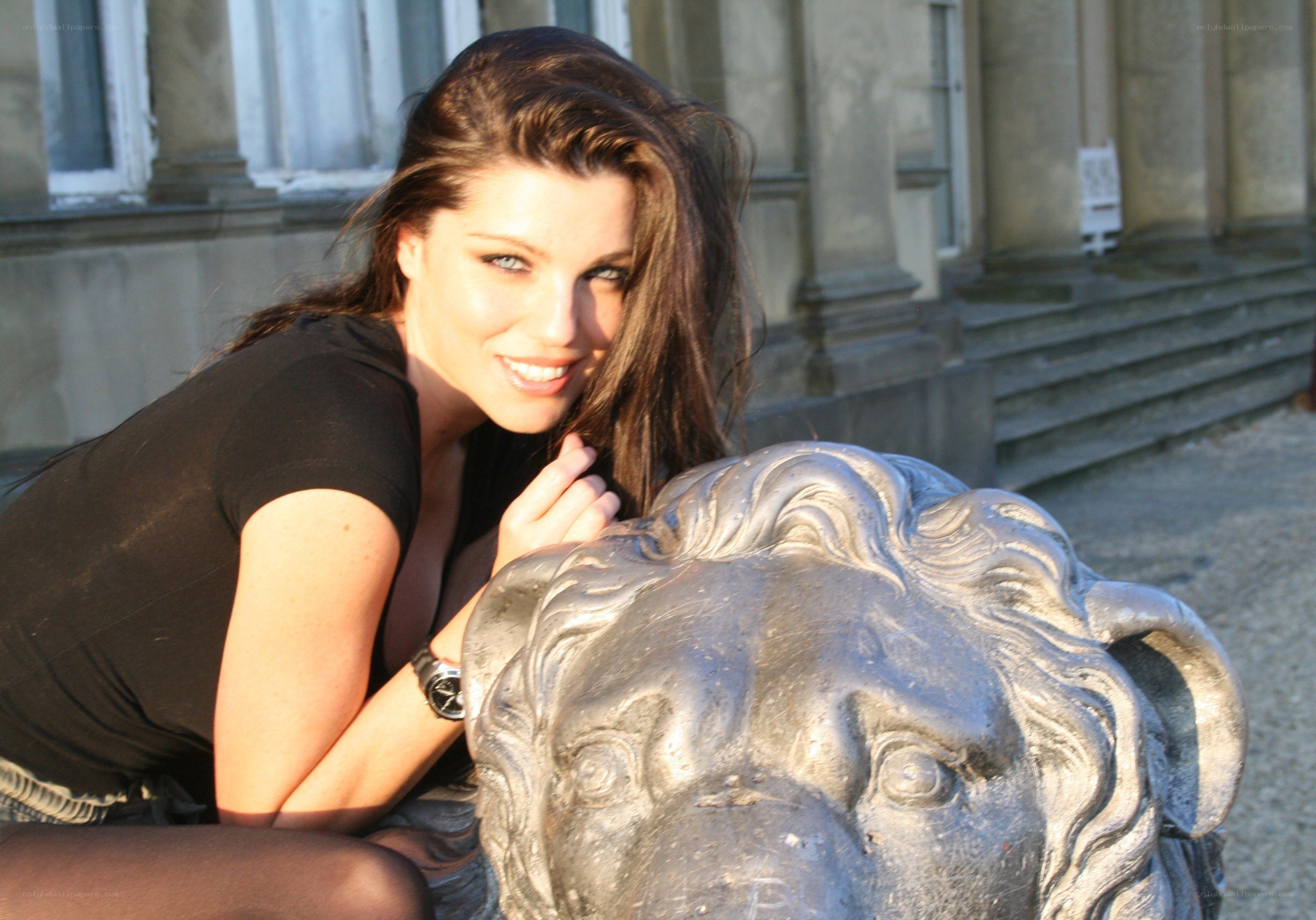 woman posing with lion statue