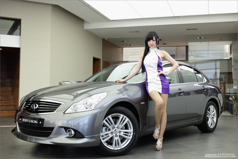 woman posing with luxury car