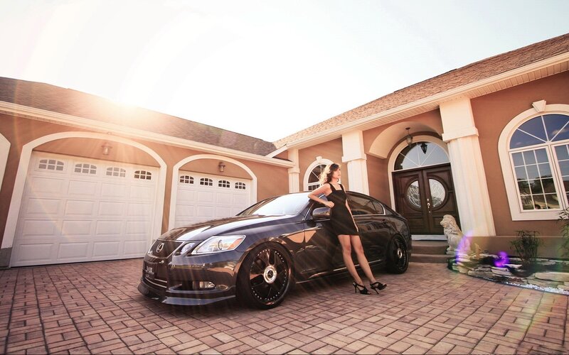woman posing with luxury car