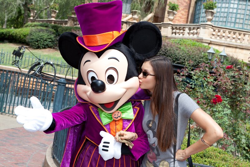 Woman posing with Mickey Mouse