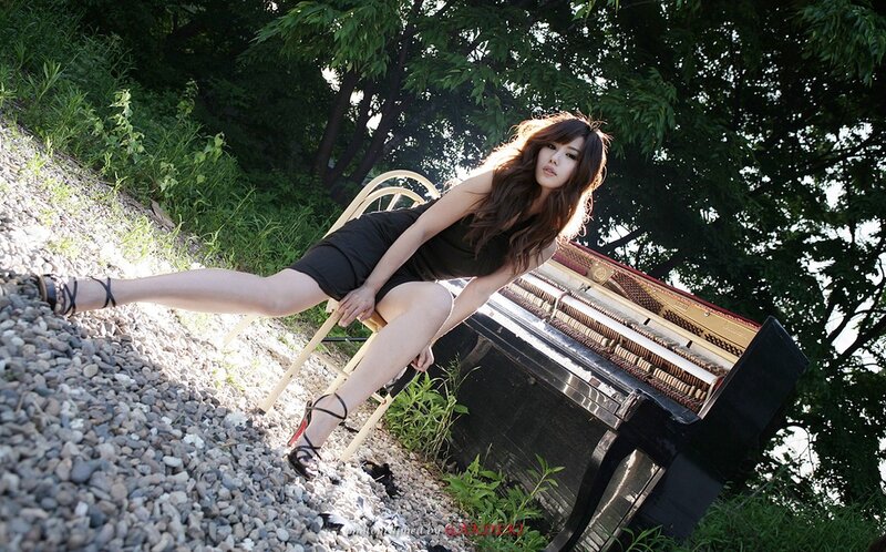 woman posing with piano outdoors