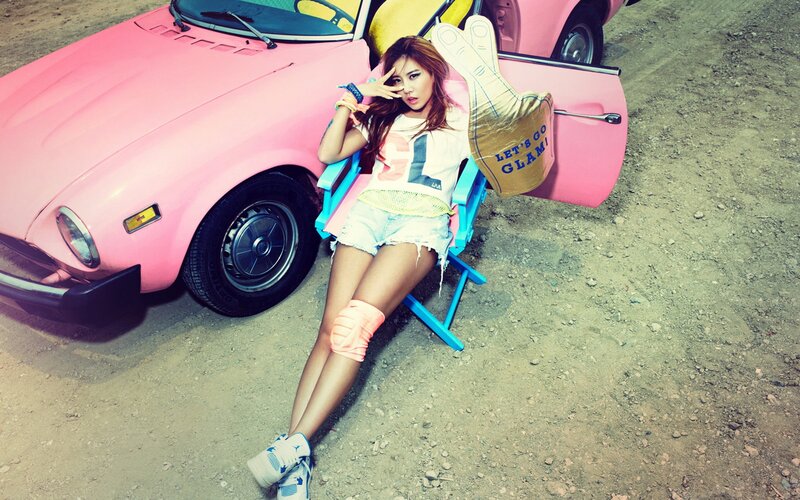 woman posing with pink car