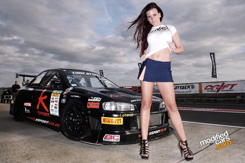 Woman Posing with Race Car — Black, Dramatic, Afternoon