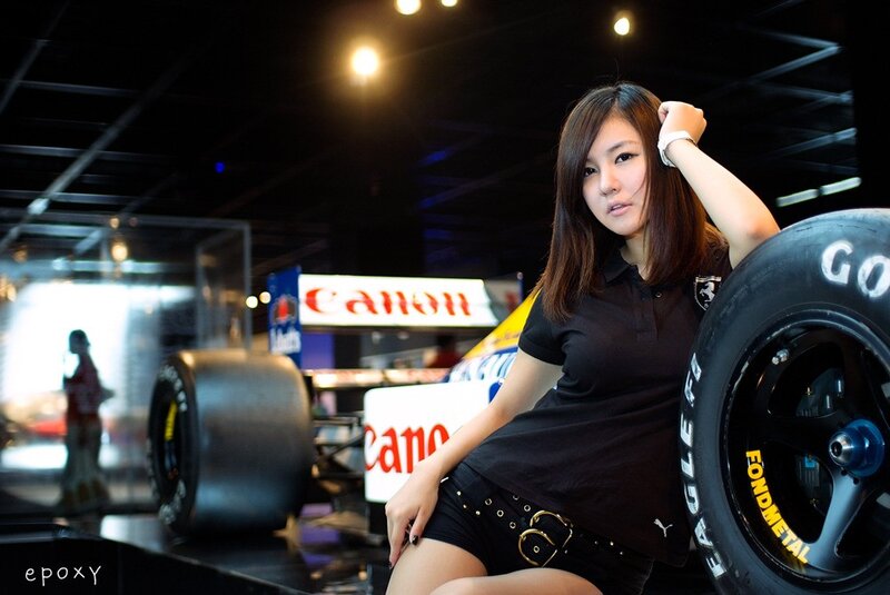 Woman posing with race car tire