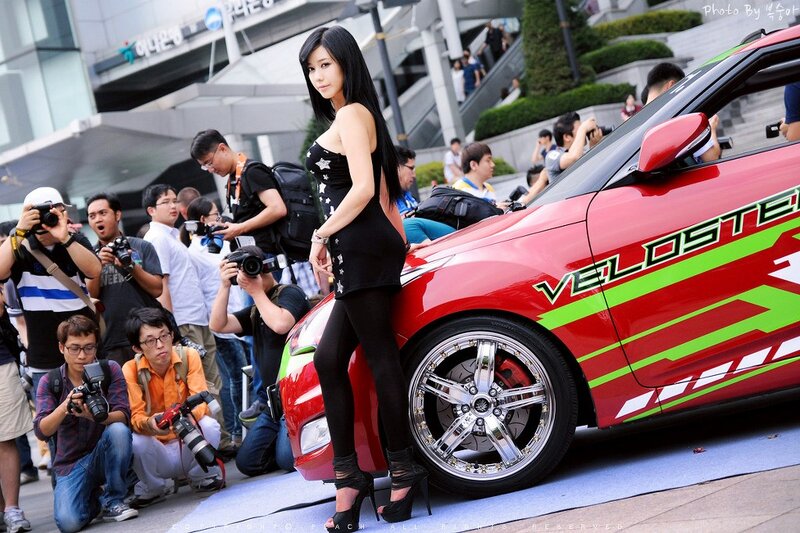 Woman Posing with Red Car — Energetic