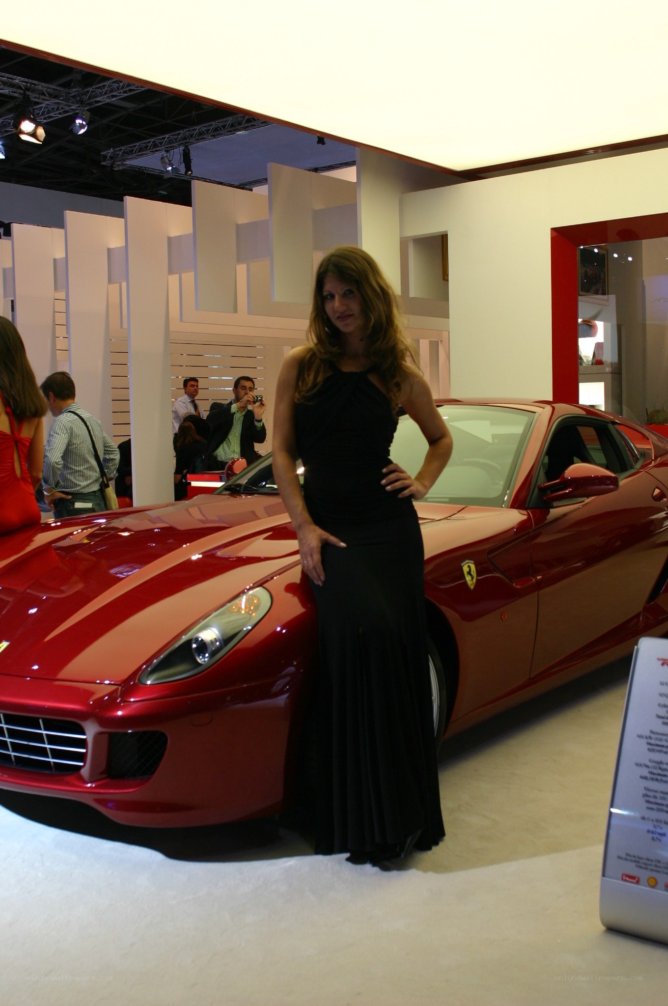Woman posing with red Ferrari