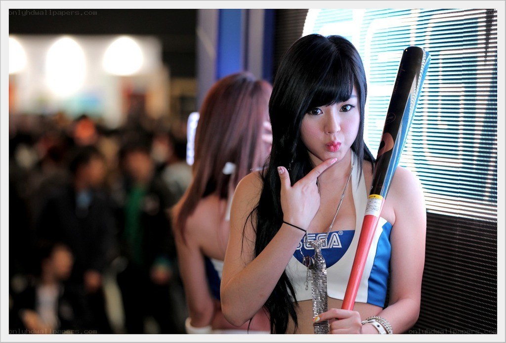 Woman posing with Sega baton