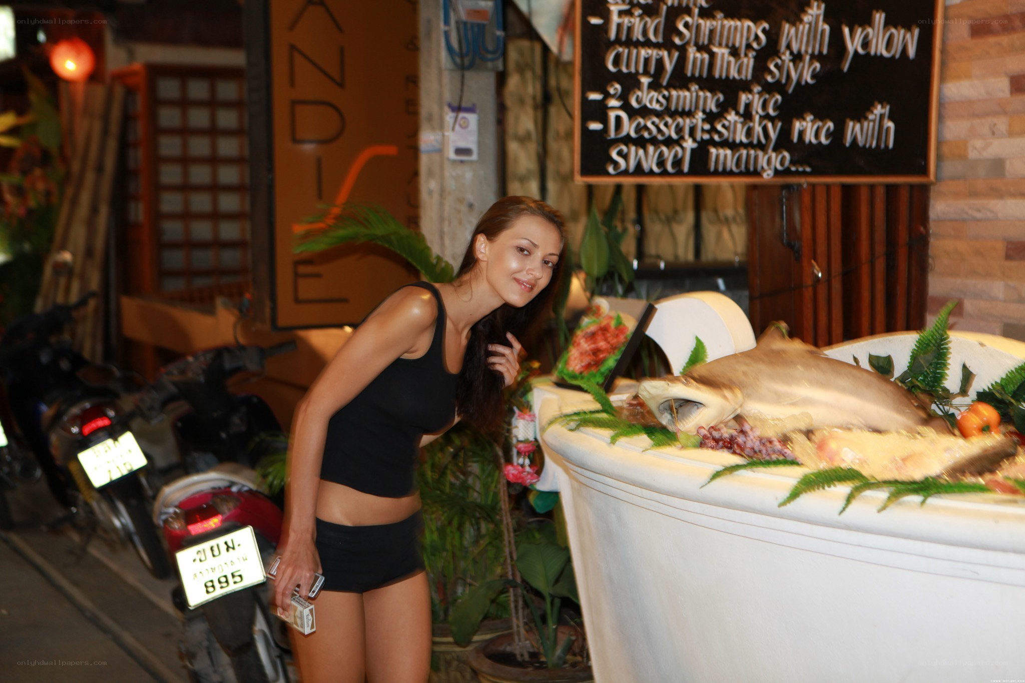 Woman posing with shark display