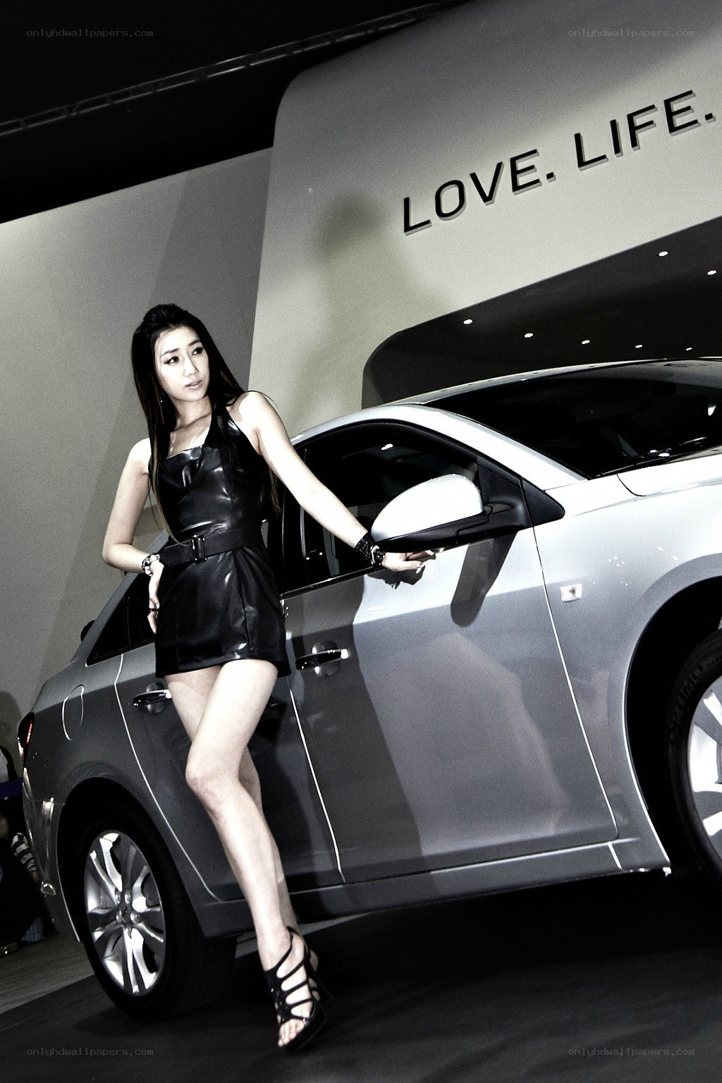 Woman posing with silver car