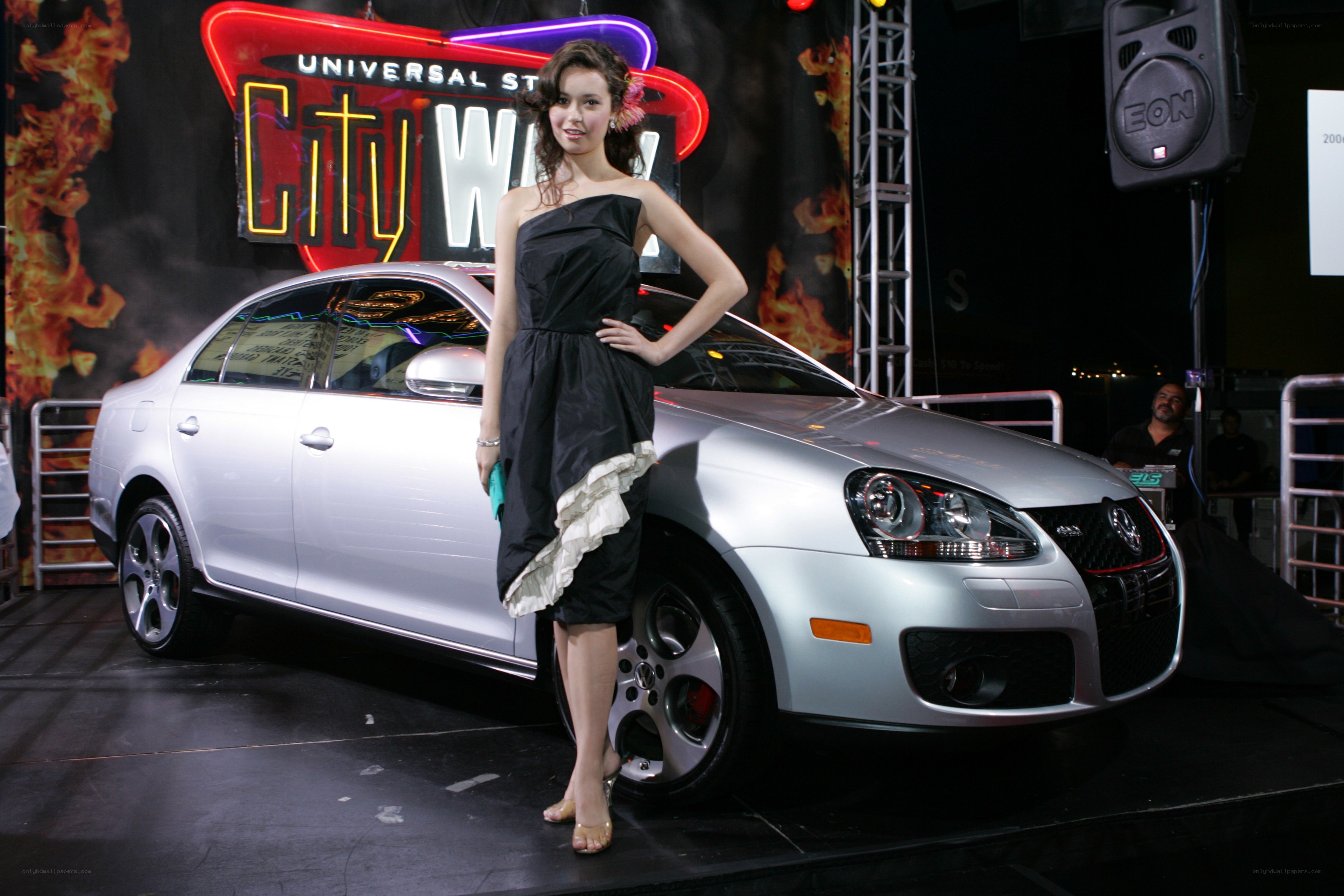 Woman posing with silver car