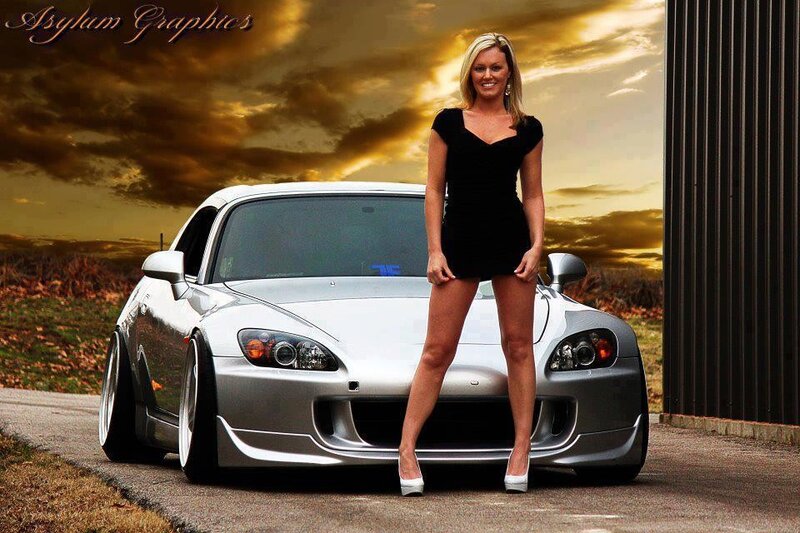 woman posing with sports car