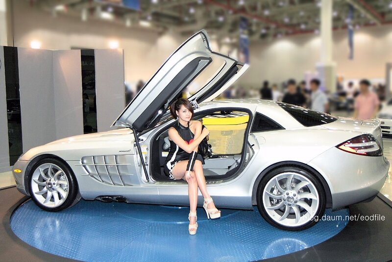 Woman posing with sports car
