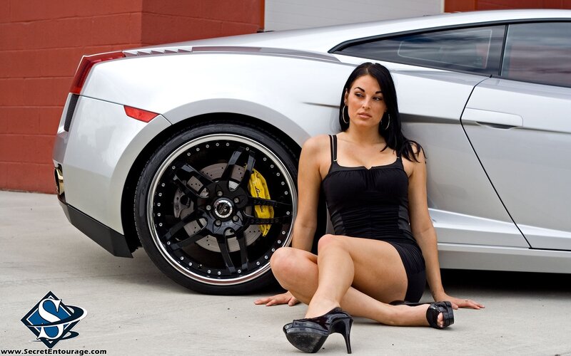 woman posing with sports car