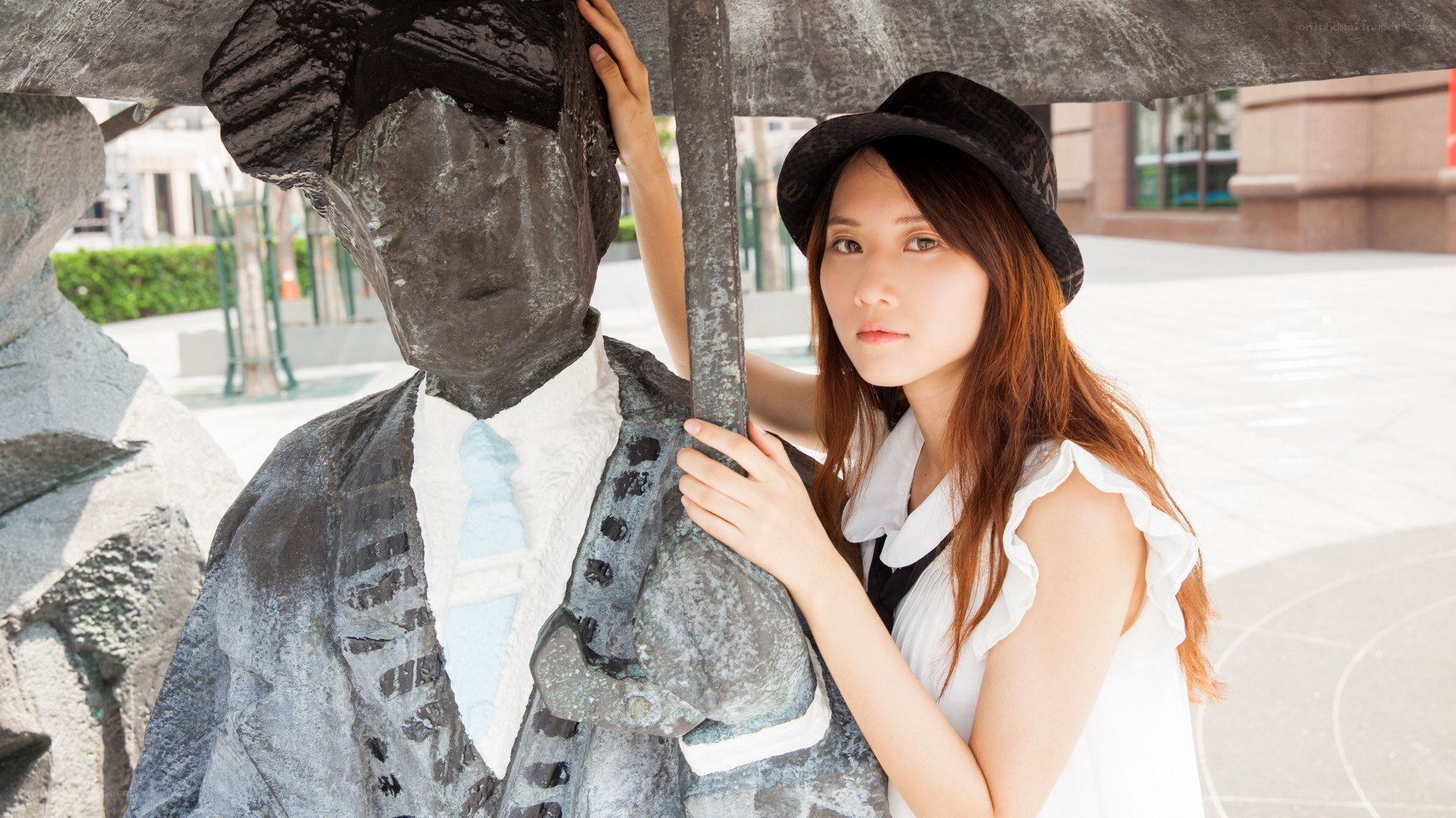 woman posing with statue