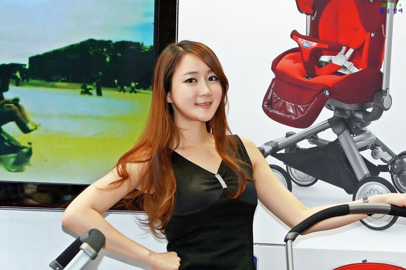 Woman posing with stroller at event