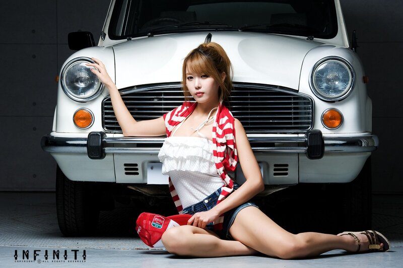 woman posing with vintage car