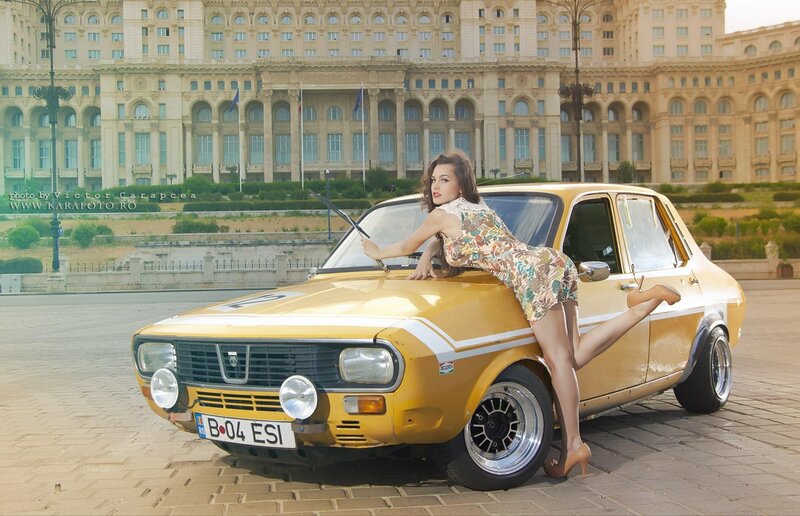 Woman posing with vintage car