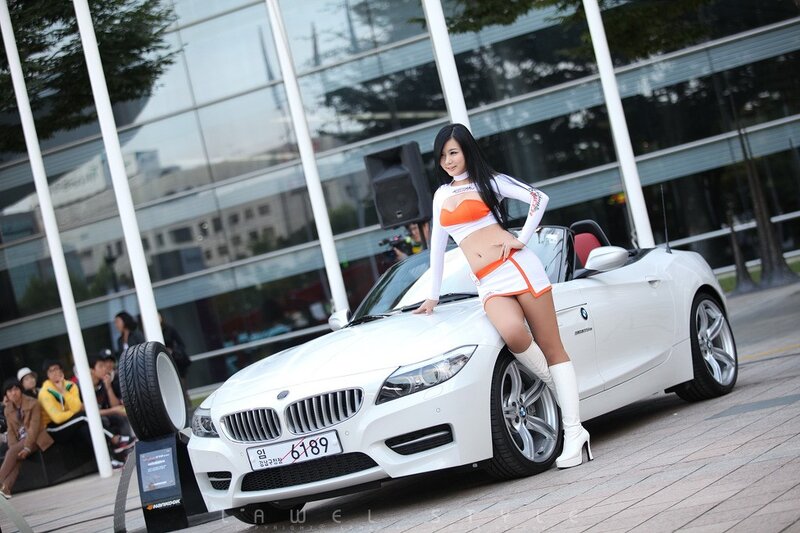 Woman posing with white BMW