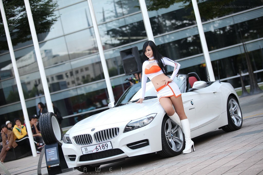 Woman posing with white BMW