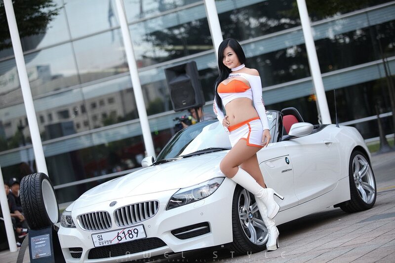 Woman posing with white BMW