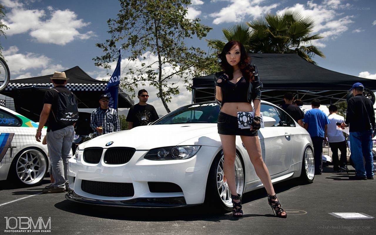Woman posing with white BMW