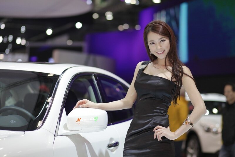 Woman posing with white car