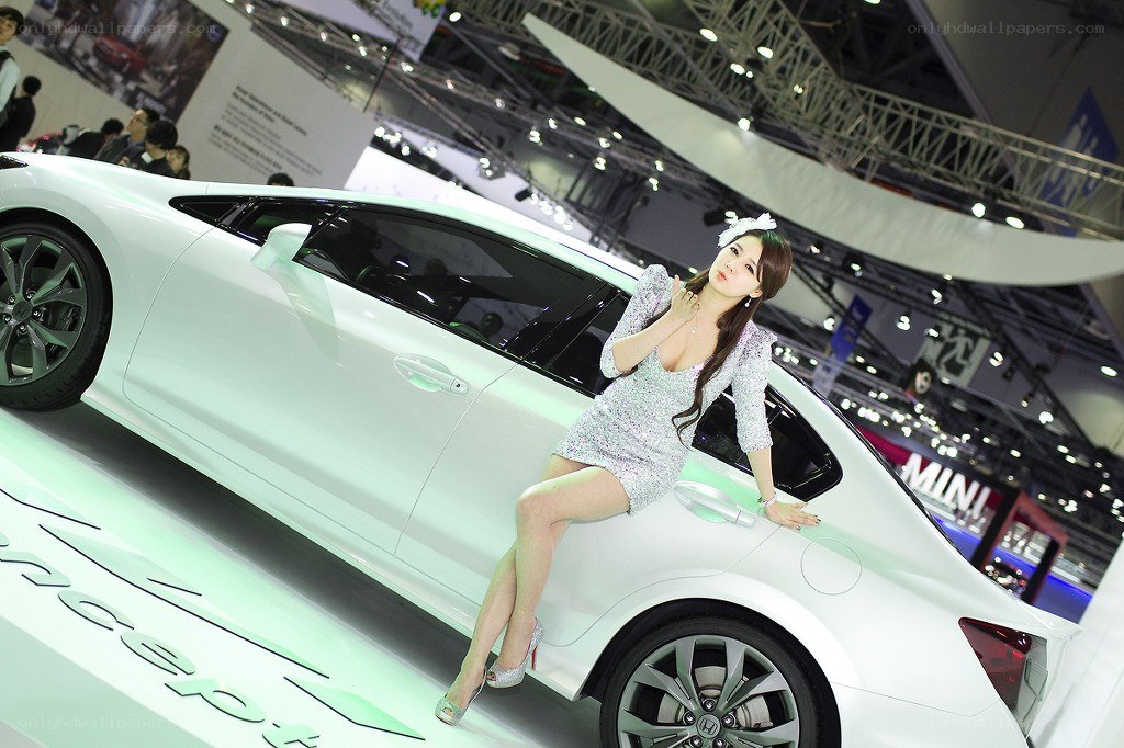 Woman posing with white car