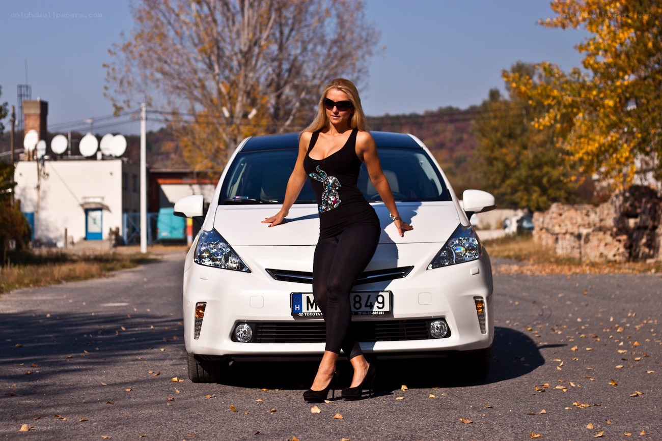 Woman posing with white car