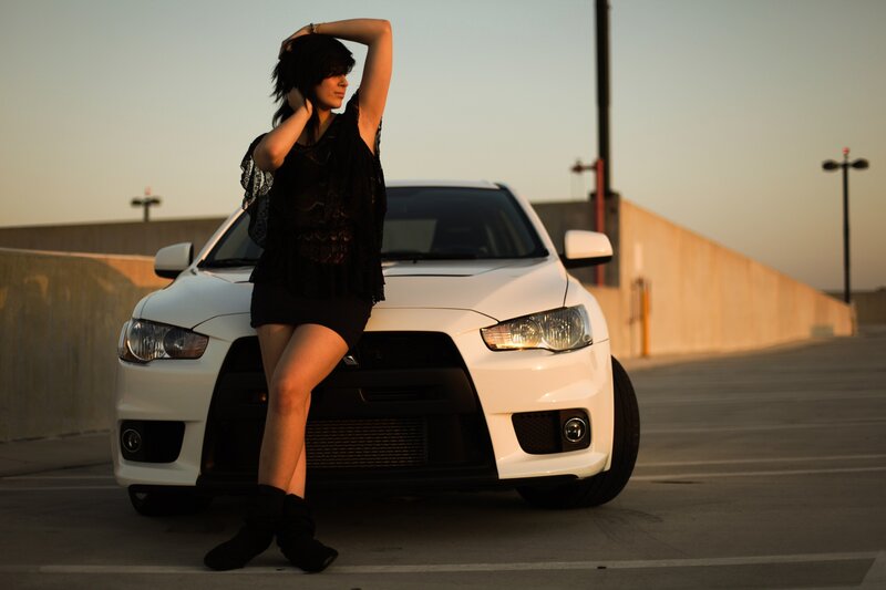 woman posing with white car
