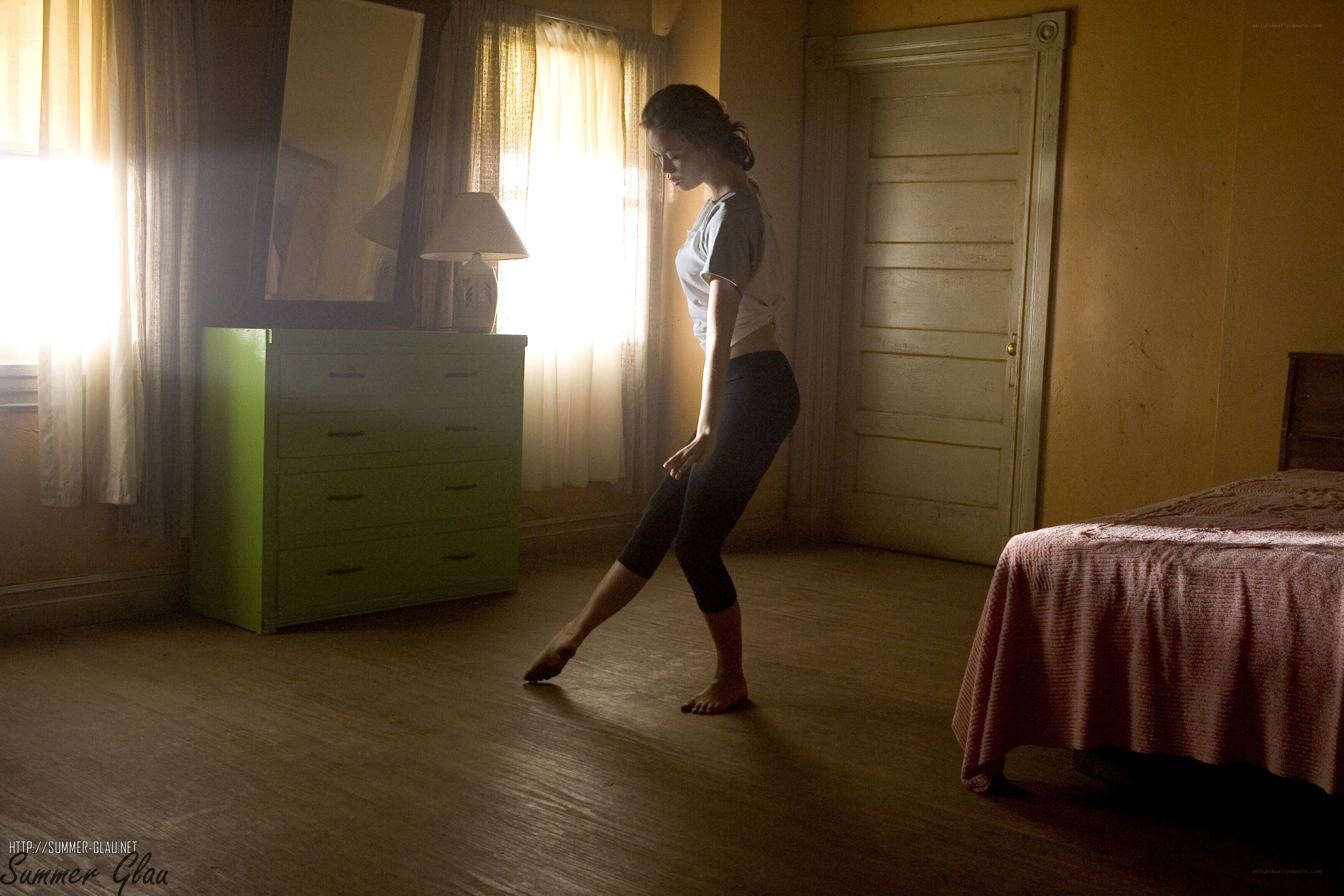 woman practicing dance in bedroom
