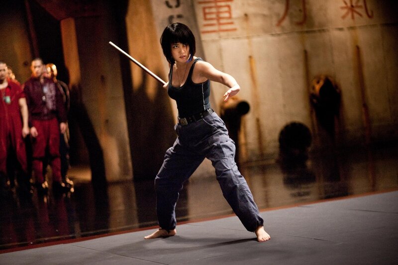 Woman practicing martial arts with staff