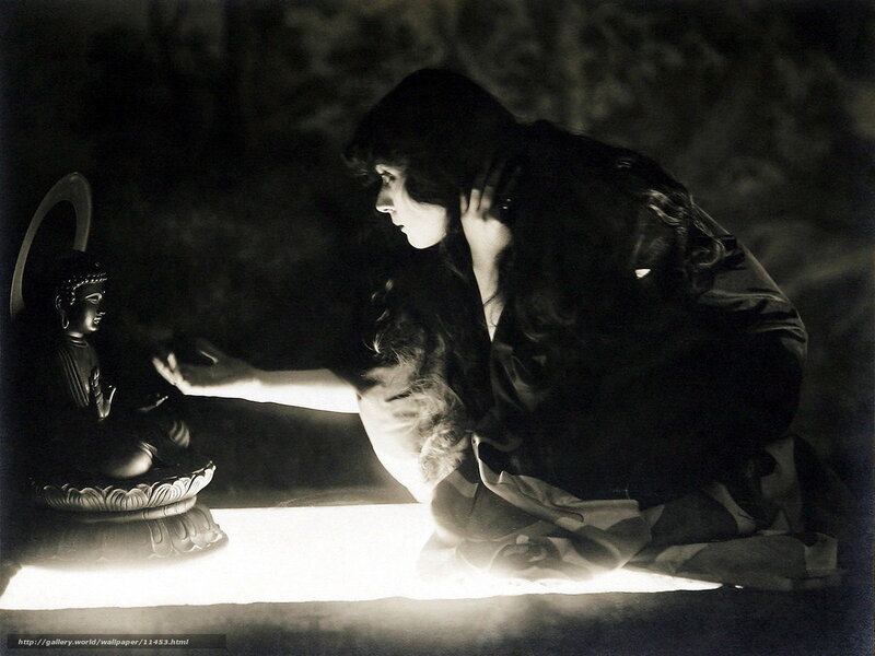Woman praying before Buddha statue