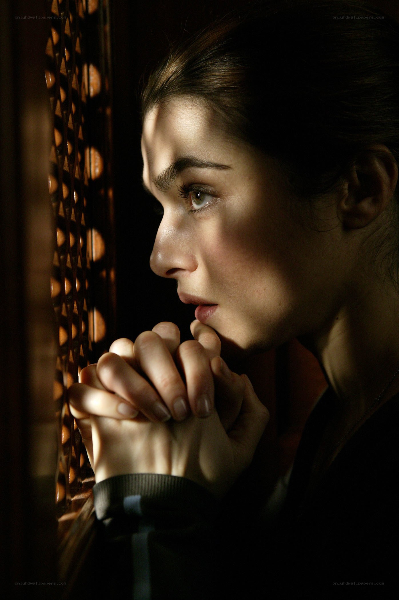 woman praying by window
