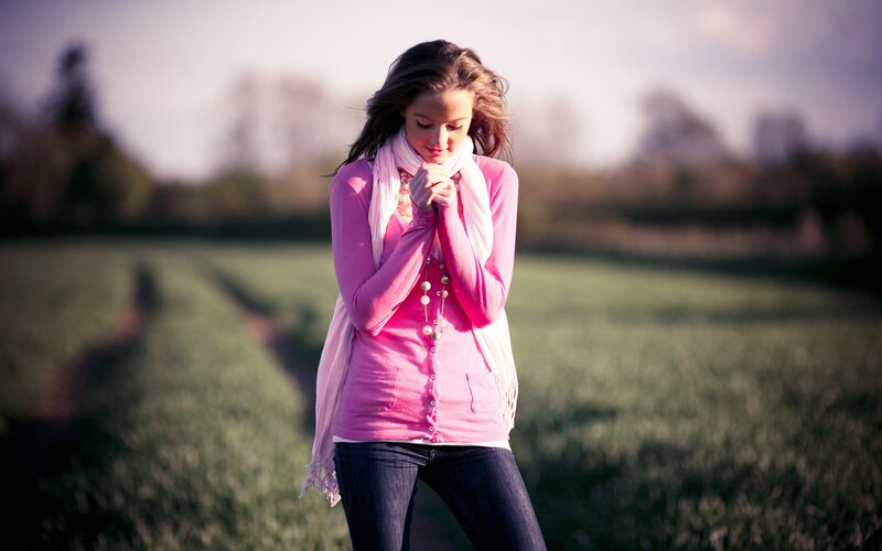 woman praying in a field