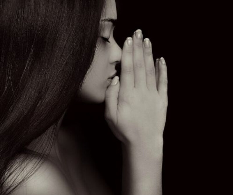 woman praying in profile