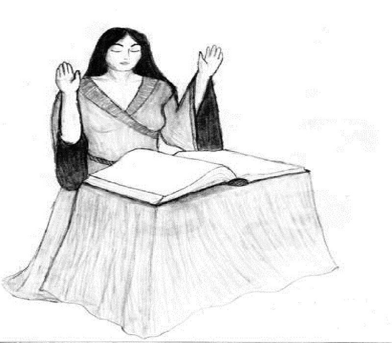 woman praying over book