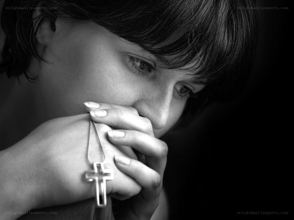 woman praying with cross