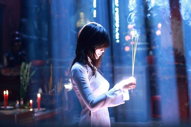 woman praying with incense