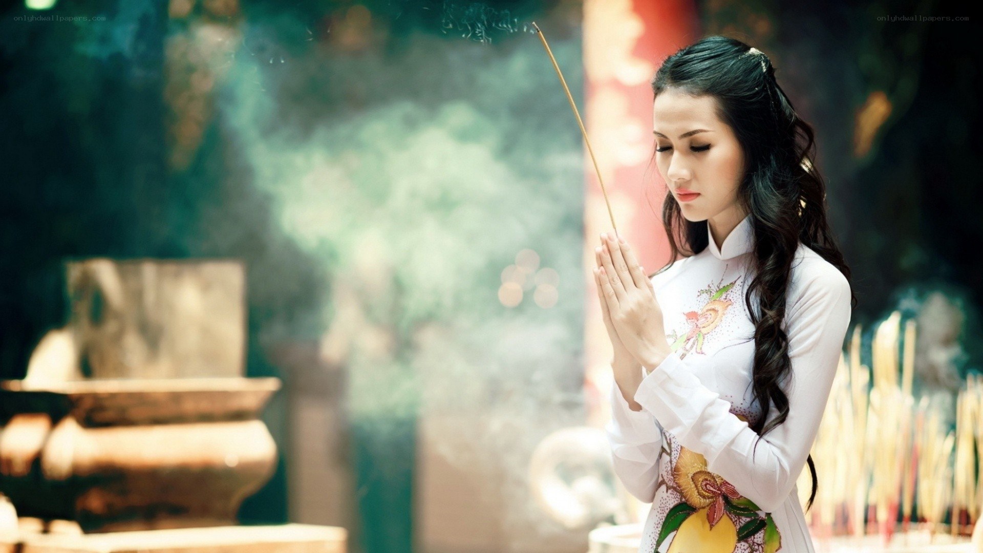 woman praying with incense