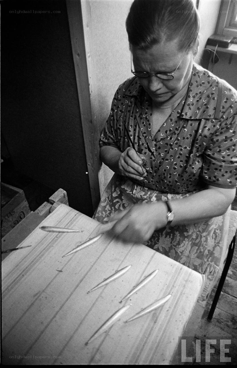 woman preparing fish on table