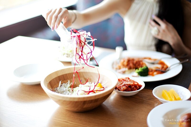woman preparing salad at table