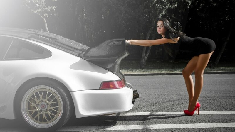 woman pushing a car